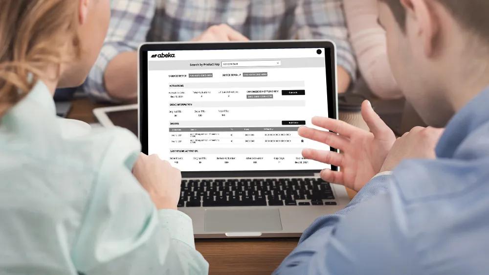 Team reviewing Abeka Academy wireframes on a laptop, designed by LXE Digital for an enterprise customer management system prototype