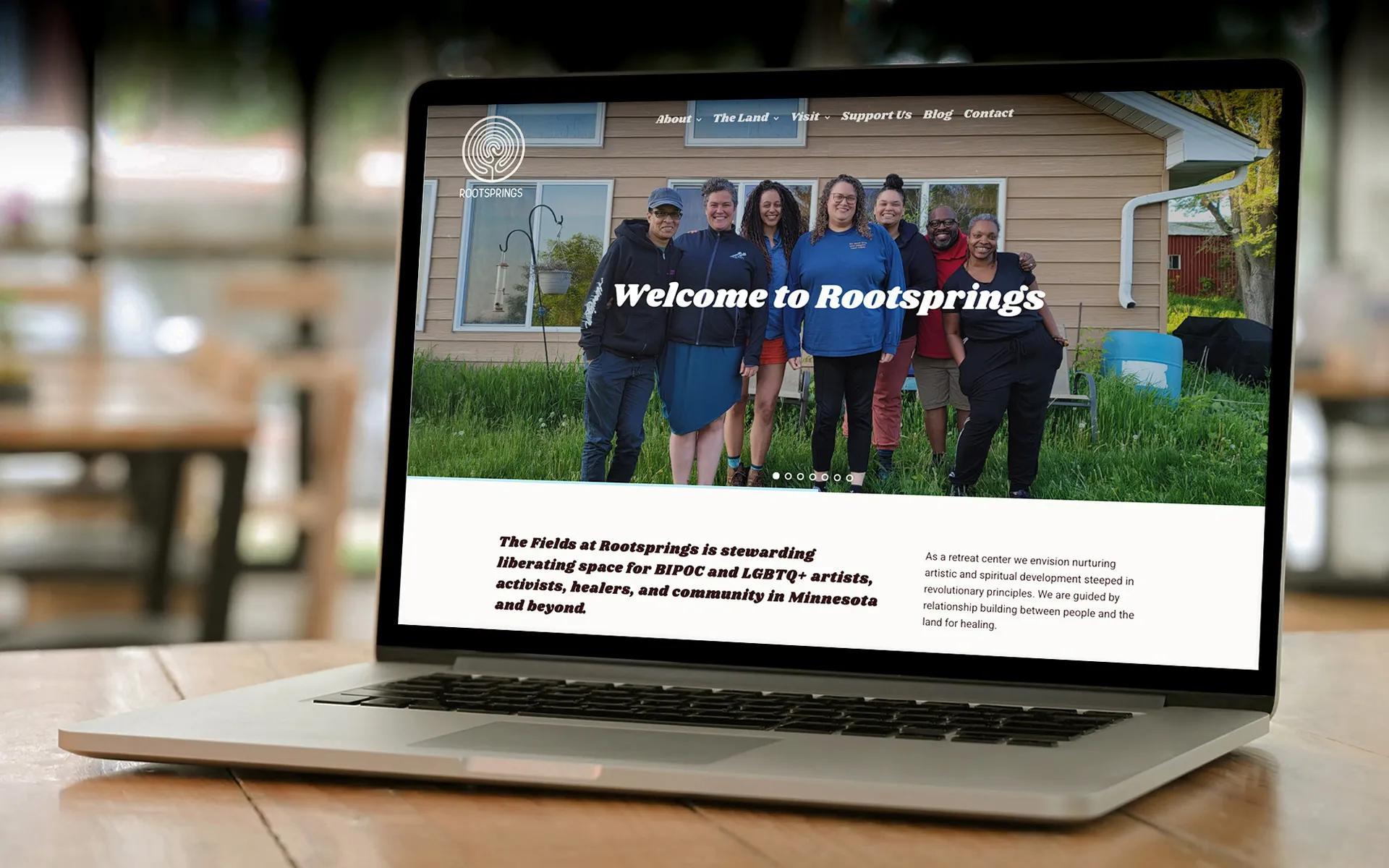 Person holding a phone showing the Rootsprings online booking calendar, part of the custom retreat center website developed by LXE Digital