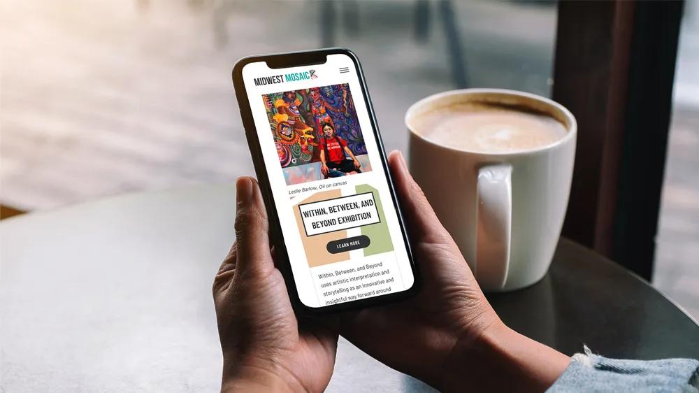Person browsing the MidWest Mosaic mobile website built by LXE Digital, showcasing a custom WordPress site for a community-focused arts organization