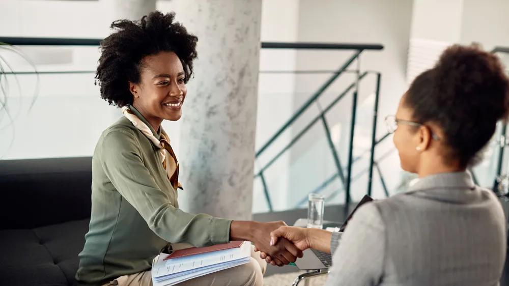 Two professionals shaking hands during a tech consulting session, representing LXE Digital’s event technology solutions for seamless conferences and conventions